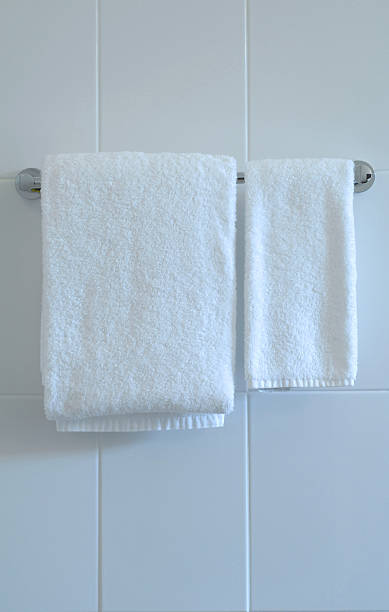 istock White bathroom towels on a towel hanger. 140210208
