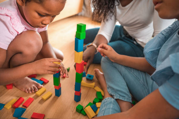 istock Mother Playing With Her Daughters At Home 1402103169