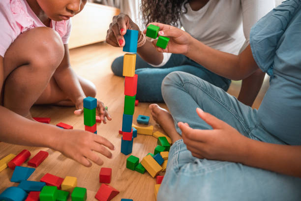 istock Mother Playing With Her Daughters At Home 1402103181