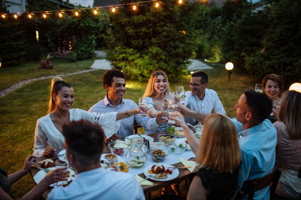 istock Friends and family eating dinner outdoors on warm summer night 1402104090