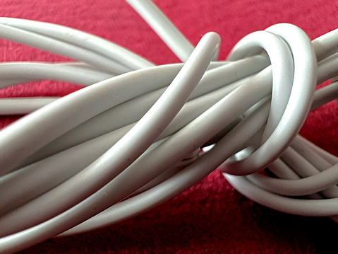 A white packed cable on red fabric background.