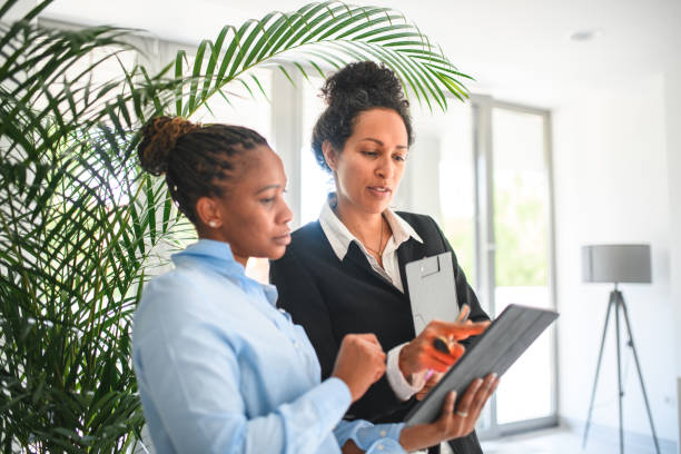istock Mature Females Work Colleagues Working With A Digital Tablet 1402104324