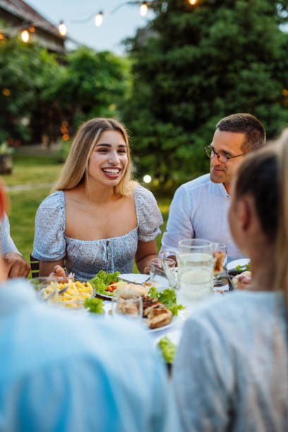 istock Multi-ethnic group of people eating in the backyard in summer evening and having fun 1402104445