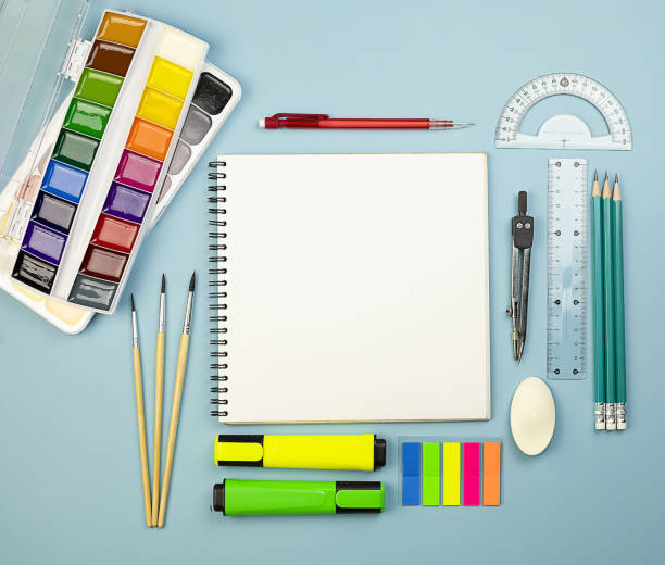 Back to school. Office on a blue background with an album and white sheets.