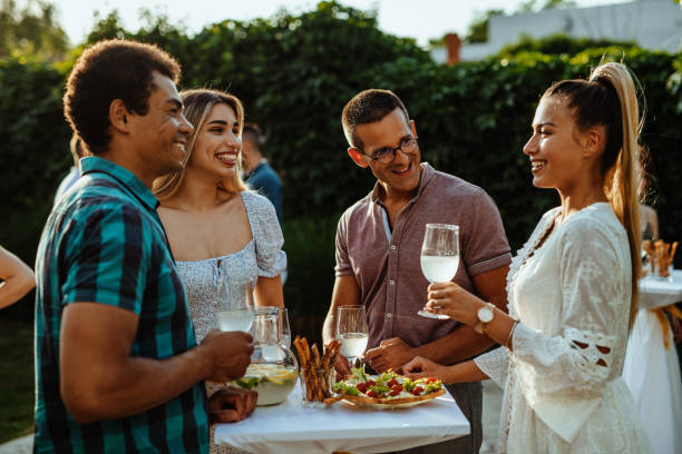 istock Couples talking and laughing on garden party in summer 1402104944