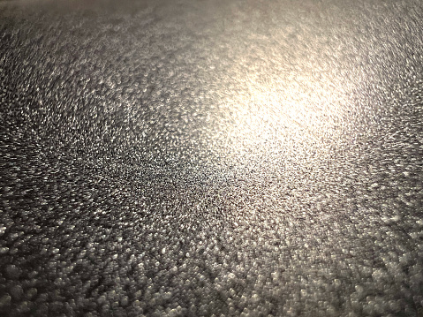 A macro image of a beautiful black metallic material.