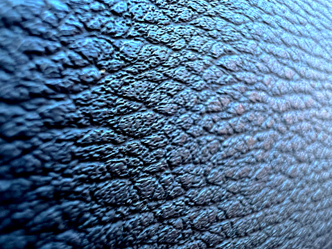 A blue plastic material with patterns as texture or background.