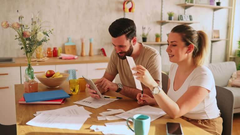 Couple checking their finances at home