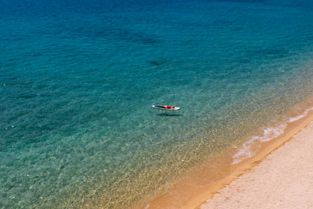 istock Woman floating on a stand up paddle 1402107623