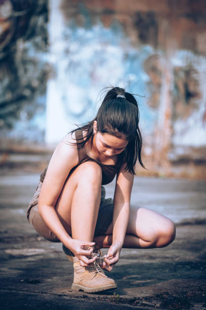 istock Cool woman tying shoelaces 1402109538