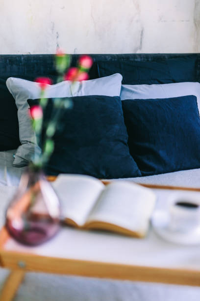 istock Coffee and flowers on bed tray in elegant bedroom 1402110997