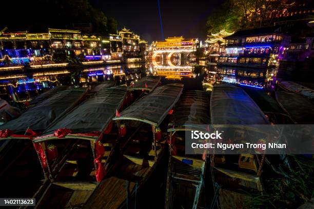 View Of Illuminated At Night Riverside Houses In Ancient Town Of Fenghuang Known As Phoenix China Stock Photo - Download Image Now