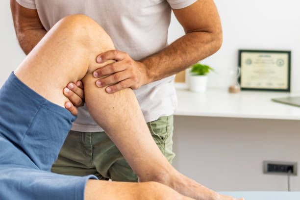 istock Doctor giving a patient a leg treatment 1402115238