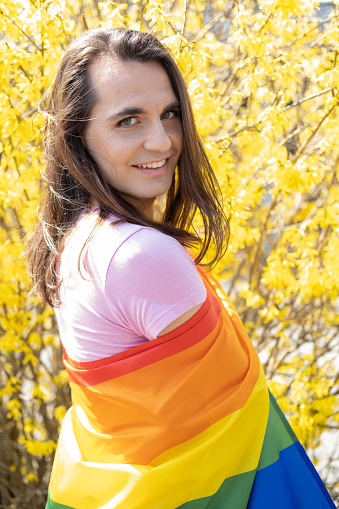 Transgender person with LGBT flag