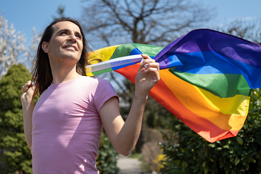 Transgender person with LGBT flag