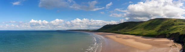 Rhossili Bay Beach On The Gower Peninsula, Wales Looking out across the spectacular Rhossili Bay Beach on the Gower Peninsula, Wales. rhossili bay stock pictures, royalty-free photos & images