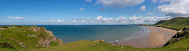 Looking out across the spectacular Rhossili Bay Beach on the Gower Peninsula, Wales.