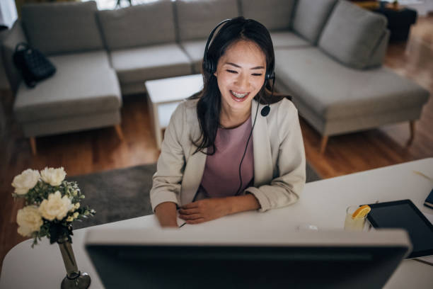 istock Young asian woman working on computer at home 1402117379