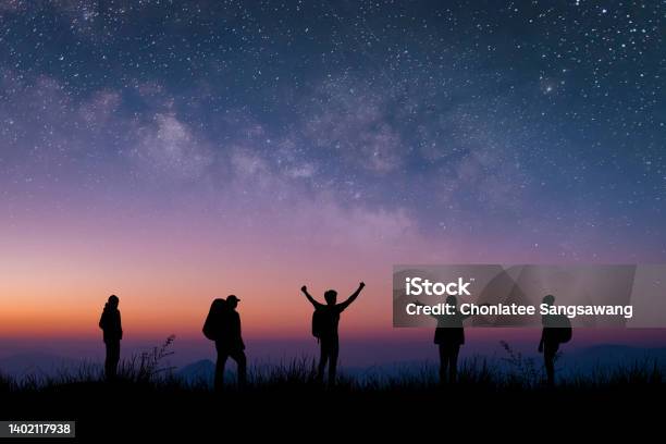 Silhouette Group Of Young Traveler And Backpacker Watched The Star And Milky Way On Top Of The Mountain With Twilight Sky He Enjoyed Traveling And Was Successful When He Reached The Summit Stock Photo - Download Image Now