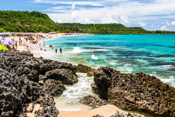 Pingtung, Taiwan- June 21, 2016: Beautiful scenery of Baishawan coastal reef and sea waves with the azure sky in the Kenting National Park, Pingtung, Taiwan.