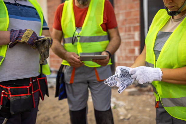 istock Unrecognizable female construction worker put on protective gloves 1402121514