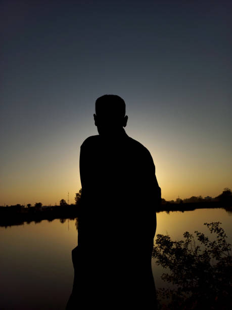 istock Boy standing on rock looking straight. 1402121805