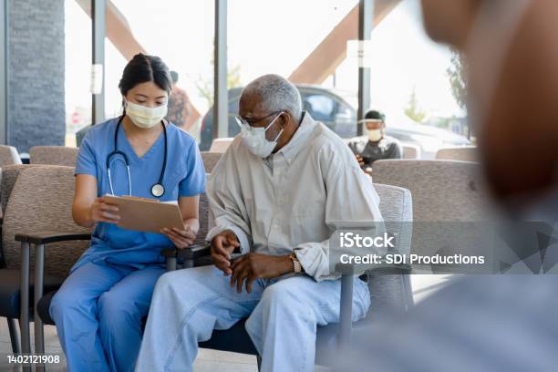 Nurse Helps Elderly Patient Stock Photo - Download Image Now - Patient, Doctor, Nurse