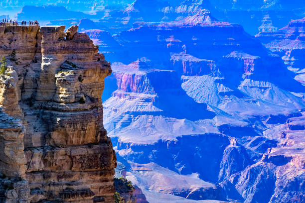 Tiny People Grand Canyon The tiny people gathered at Mather Point show to immense scale of the Grand Canyon in the early evening light. south rim stock pictures, royalty-free photos & images