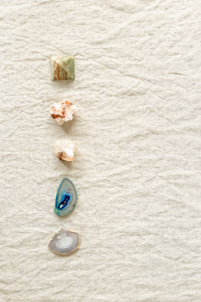 istock Top view different crystals and stones in row on table, healing minerals agate, quartz, amethyst, onyx. Stones for crystal therapy. Flat lay semiprecious gems, alternative medicine concept 1402122943