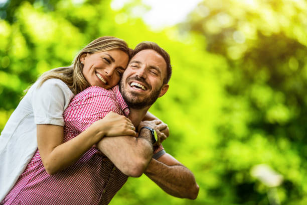 istock Happy young couple embracing on spring day in the park. 1402123974