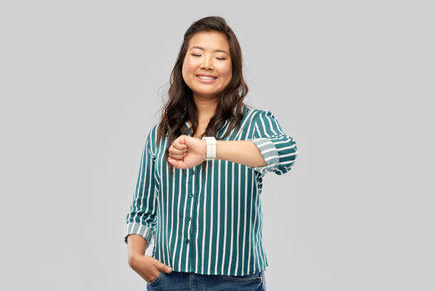 istock happy smiling woman with smart watch 1402128074
