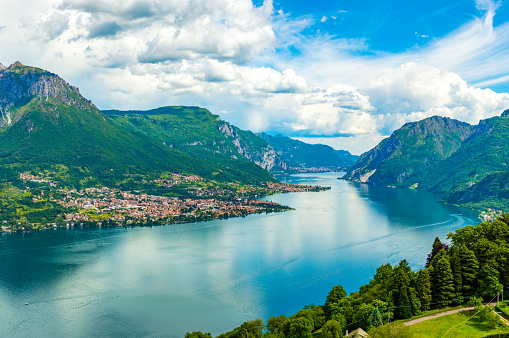 Panoramic image of the Lecco shore of Lake Como, with the mountains and villages of the province of Lecco.