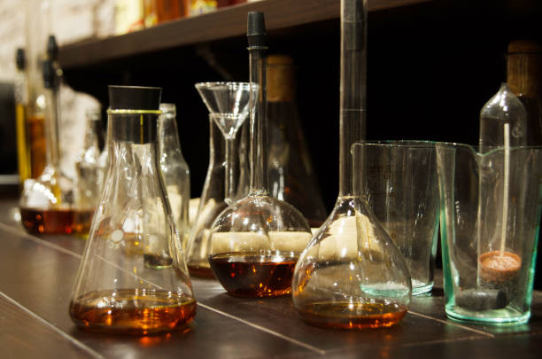 istock Testing chemical laboratory for analysis quality of alcohol, wine, cognac and whiskey. Bottle, bulb and flask. 1402128932