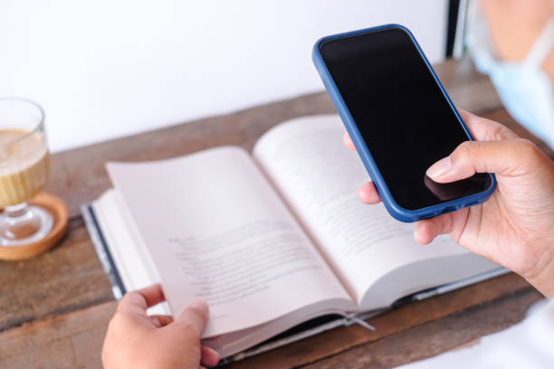 istock Capture the content on the book with a smartphone 1402129776