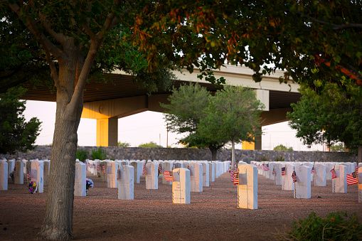 The sun set on the graves of a west Texas national cemetery on the night before memorial day.