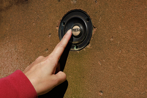 Woman pressing an old button with \