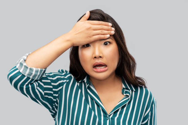 istock stressed asian woman holding to her head 1402132072