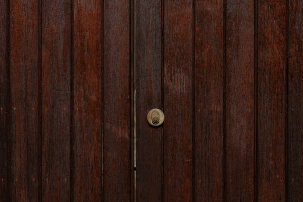 Part of a locked wooden gate.