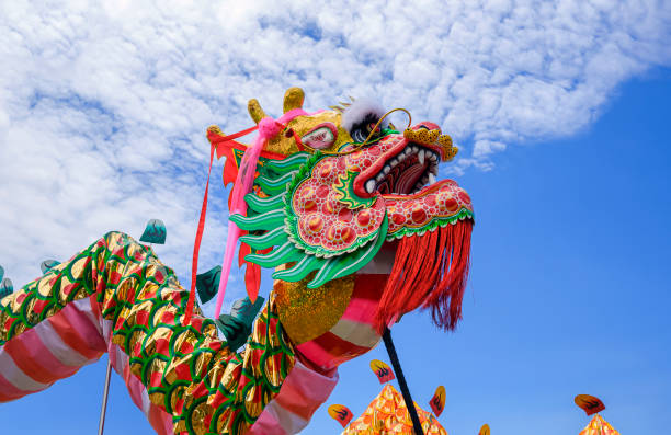 istock Colorful Chinese dragon dance performances celebration against clouds on blue sky background 1402132755