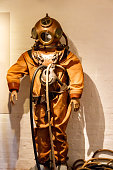 istock Old diving suit, bronze helmet and diving apparatus 1402133514