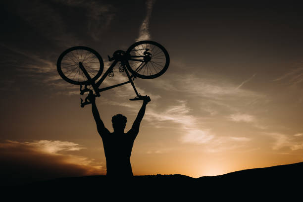 istock silhouette cyclist in the sunset 1402134783