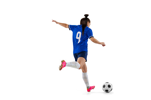 Energy. Dynamic portrait of female professional soccer, football player practicing isolated on white studio background. Concept of sport, fitness, women in sports. Young sportive girl in motion.