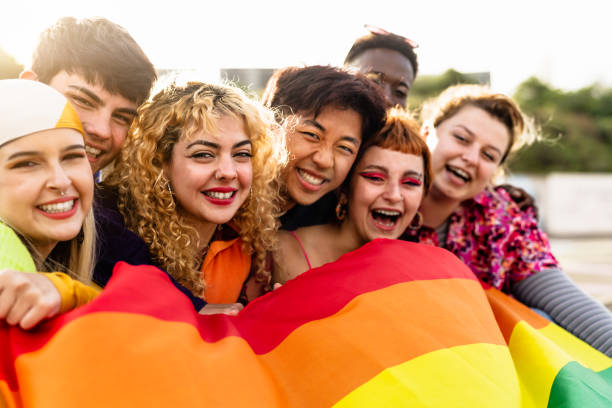 Diverse young friends celebrating gay pride festival - LGBTQ community concept stock photo