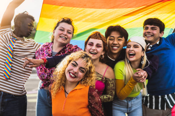 Happy diverse young friends celebrating gay pride festival - LGBTQ community concept stock photo