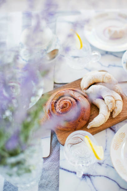 istock Pastry loaf and glass for lemonade 1402135499
