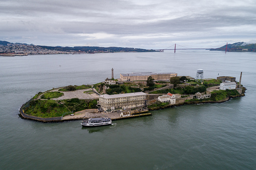 Aerial view of Alcatraz island in the San Francisco Bay. USA. The most famous Alcatraz Prison, Jail. Sightseeing Place. San Francisco Cityscape in Background.