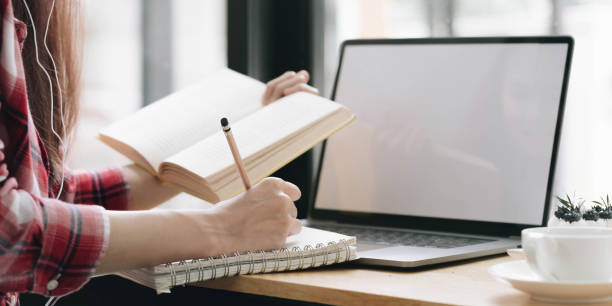 istock Cropped image Young female freelancer blogger influencer writing notes on her diary 1402138282