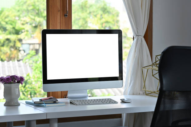 istock Front view computer with blank white screen in the office, for business and technology concept. 1402138575