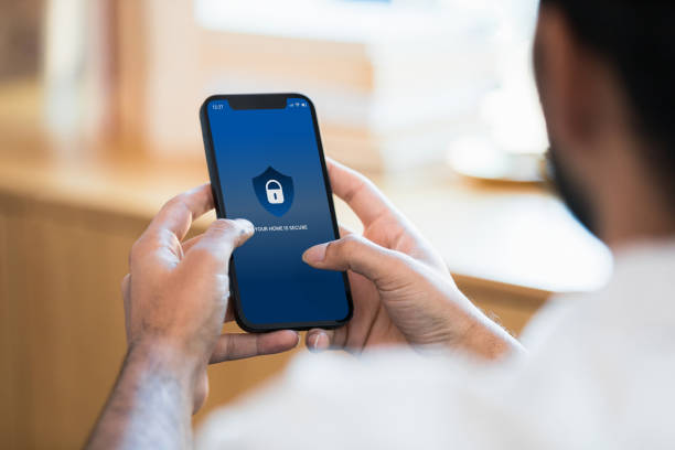 istock Unrecognizable man uses mobile app to lock door remotely 1402139832