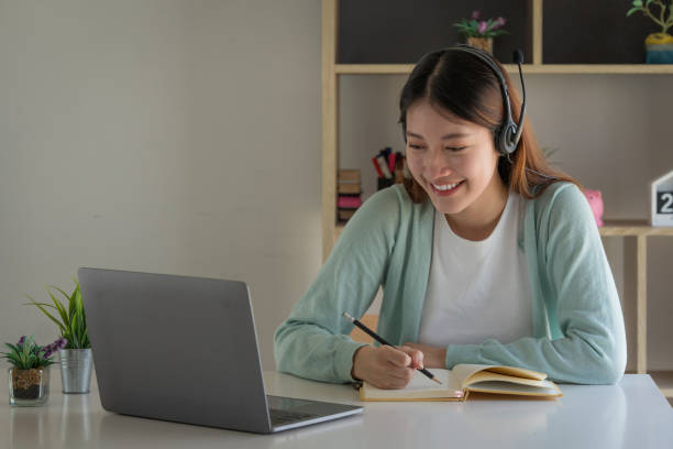 istock E-learning ,online ,education and internet social distancing protect from COVID-19 viruses concept. Asian woman student video conference e-learning with teacher on laptop computer at home. 1402141936